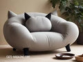 A light gray, oversized cat-themed sofa featuring integrated pointed ears and a round back cushion with black ears.